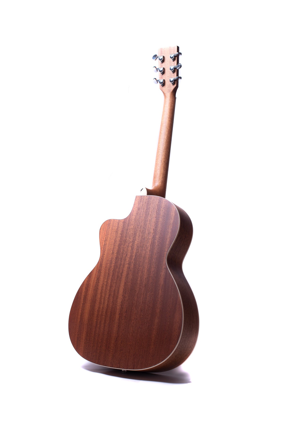 A wooden acoustic guitar viewed from the back, showing smooth, brown wood grain and six tuning pegs on the headstock.