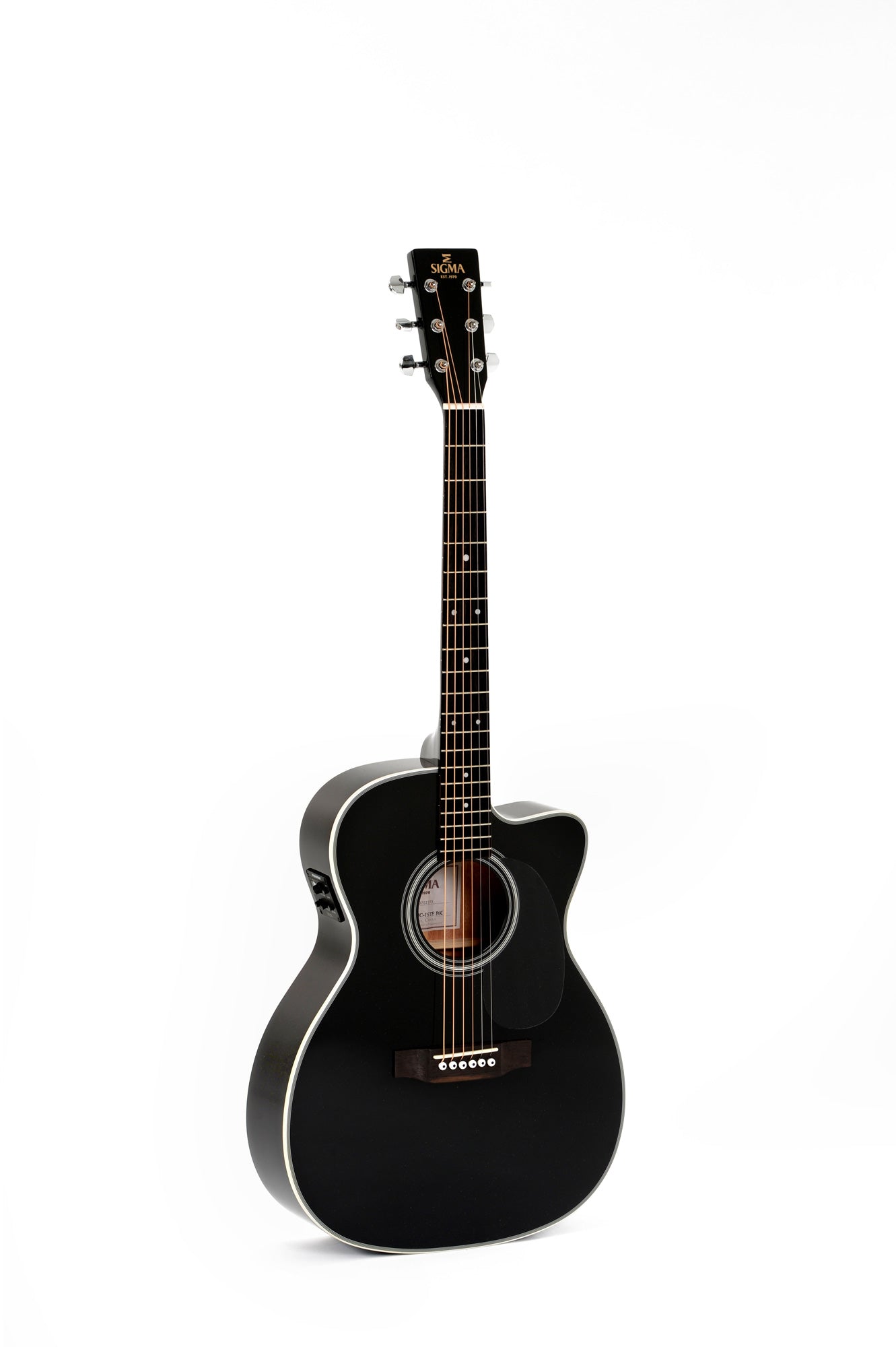 Black acoustic guitar with white trim, cutaway body, six steel strings, and silver tuning pegs. Circular sound hole features an inner label.
