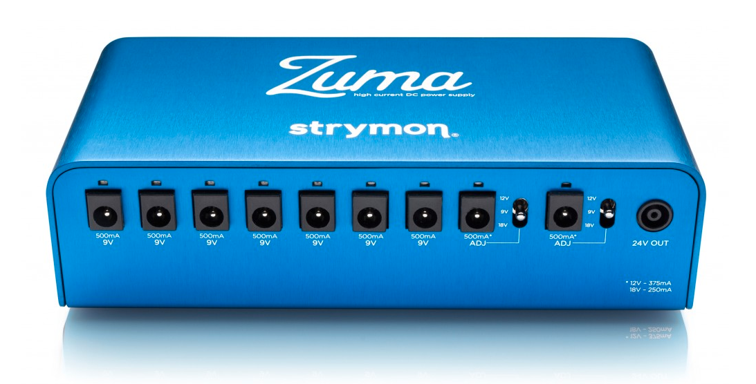 Blue Strymon Zuma effects pedal power supply with nine DC outputs labeled for 9V and adjustable 9V/12V/18V, plus a 24V output on the right.