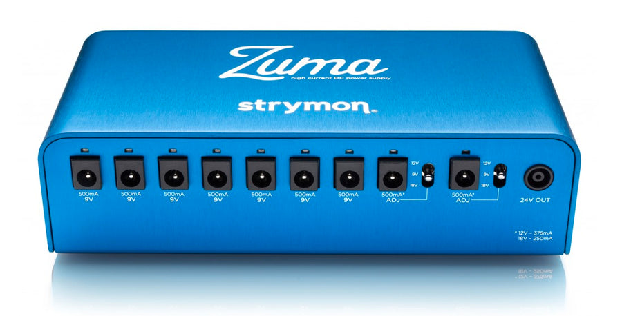 Blue Strymon Zuma effects pedal power supply with nine DC outputs labeled for 9V and adjustable 9V/12V/18V, plus a 24V output on the right.