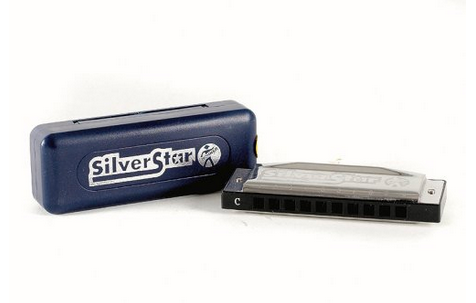 A SilverStar harmonica in key of C sits next to its blue plastic case, both labeled with the SilverStar logo.