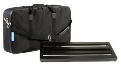 Black soft carrying case with handles and shoulder strap placed behind a rectangular metal pedalboard with three horizontal slots.