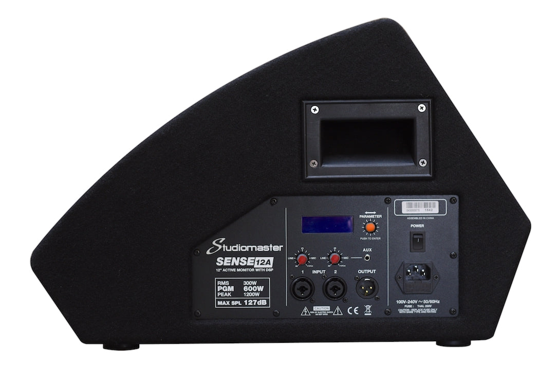 Studiomaster Sense12A speaker monitor showing rear panel with input/output ports, power switch, digital display, controls, and a handle.