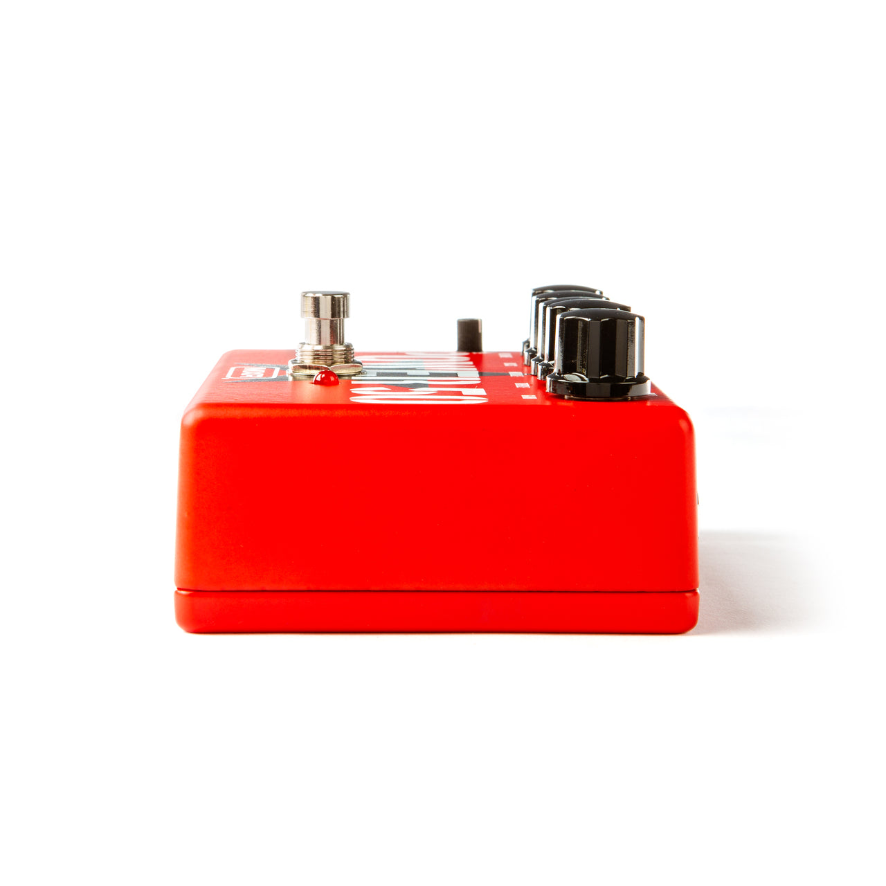 Red FX pedal viewed from the side, featuring a silver footswitch, small red LED, and three black control knobs along the top edge.